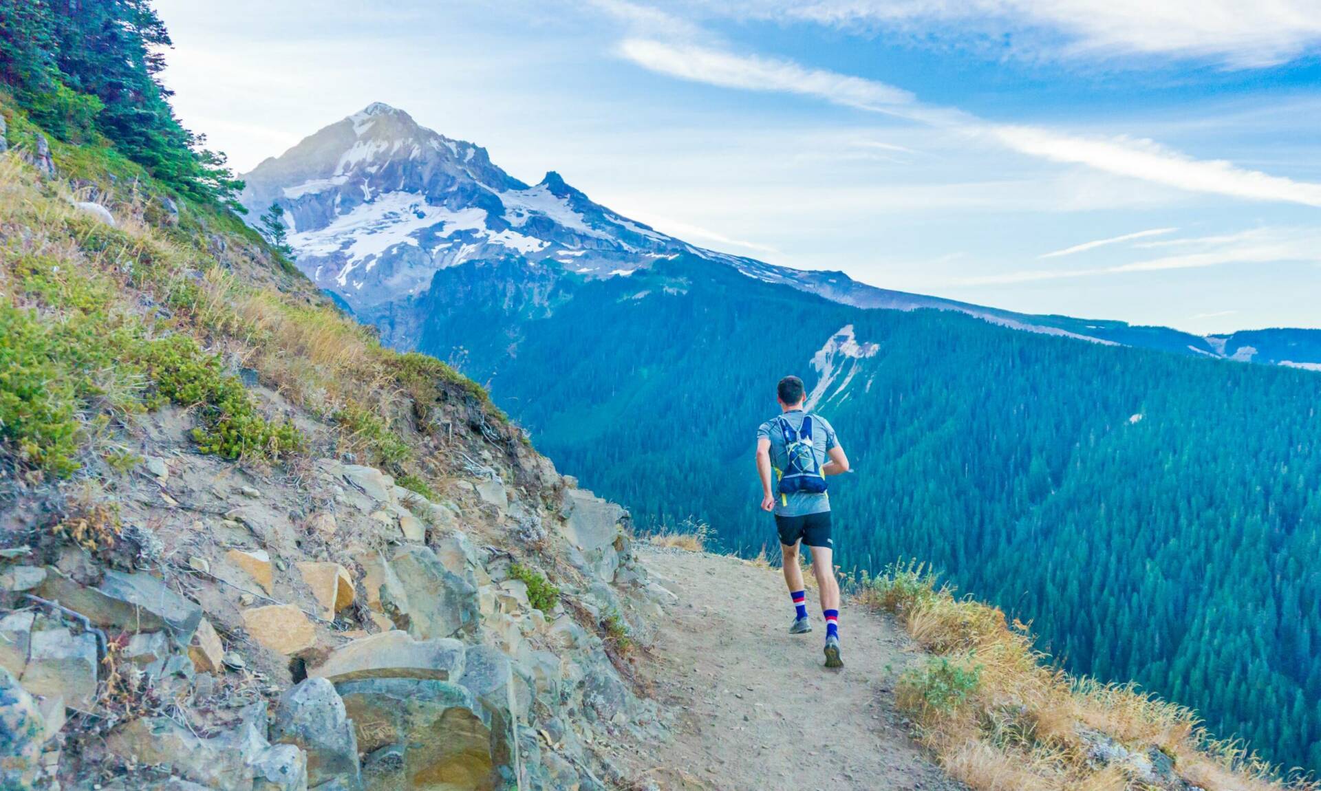 It seemed like a crazy dream: could we run a 43 mile hiking route in one day? Neither of us had ever tried such an ambitious adventure. Here, my friend spots the mountain for the first time. We made it around!