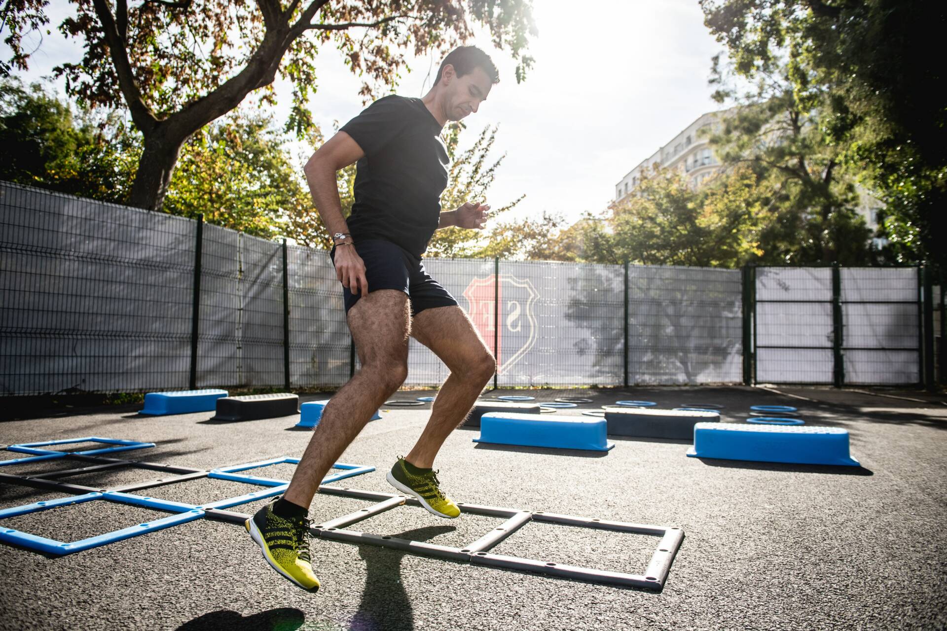 man in gray t-shirt and black shorts running on yellow and black skateboard during daytime